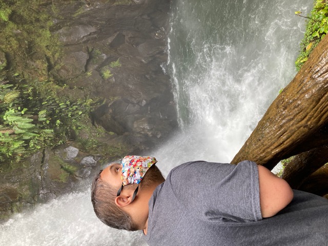 boy wearing mask listening to waterfall waterfall